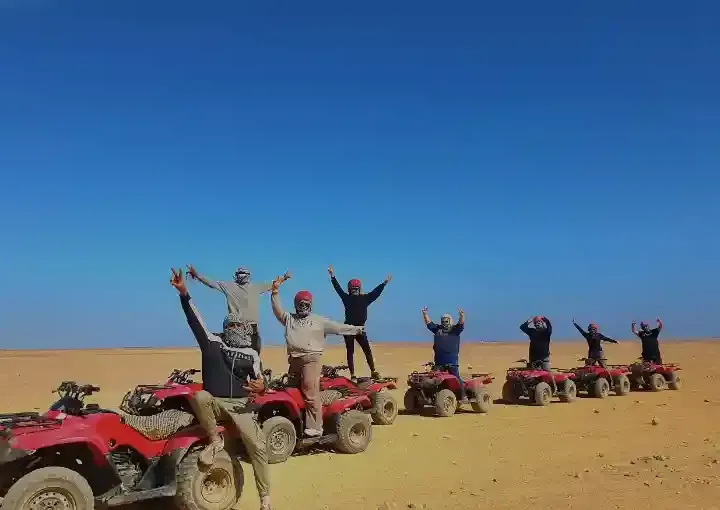 group of friends on quad bikes desert safari